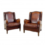 Set of two vintage sheep leather wingback armchairs